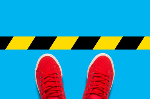standing behind tape